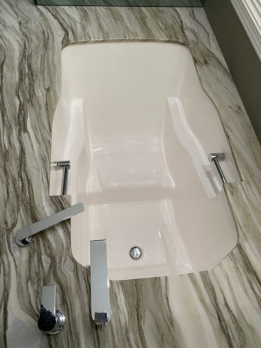 An overhead view showing the soaking tub's grab bars, armrests and internal seat