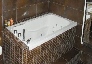 The Nirvana soaking tub in a tiled surround, here used as a corner bath